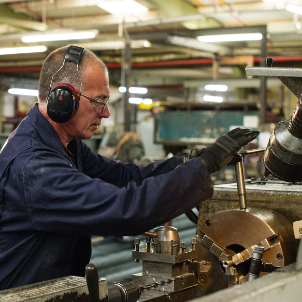 Engineer using a lathe